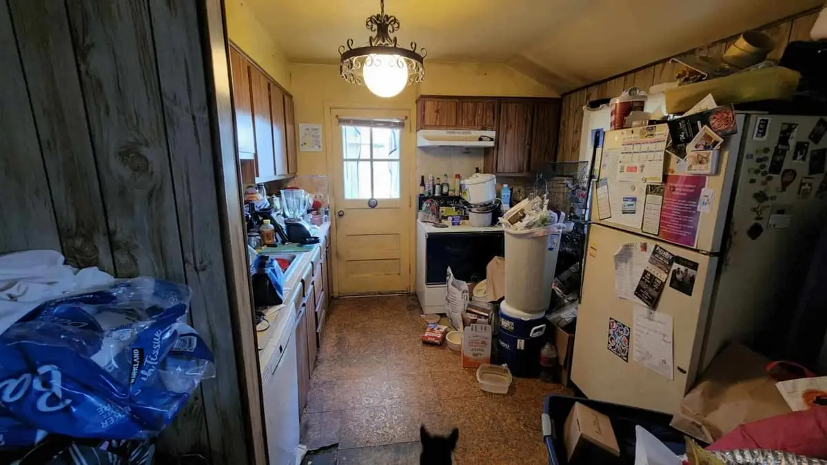 Selling a house with multiple heirs in Brentwood: kitchen with wood paneling and every surface covered
