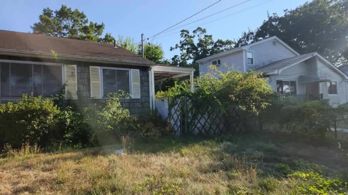 Selling a house with a lien in Brentwood: ranch behind an overgrown front lawn and hedges