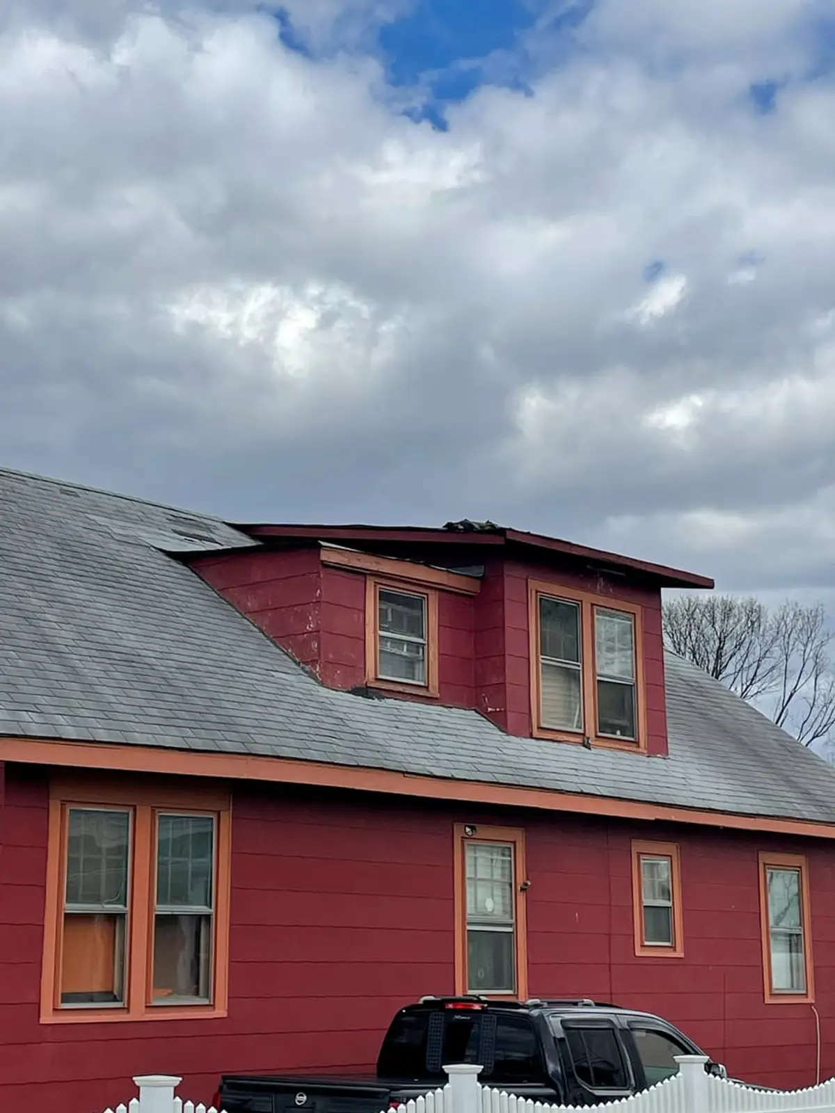 Selling a house in pre-foreclosure in Brentwood: red two-story house with a gabled dormer